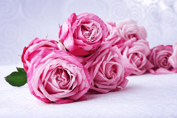 Bouquet of beautiful fresh roses on wooden table, closeup