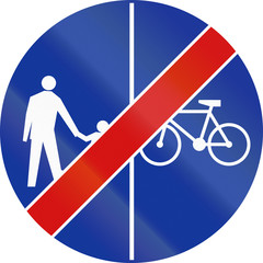 Polish traffic sign at the end of a shared-use path with separate lanes, right lane for bicycles and left lane for pedestrians