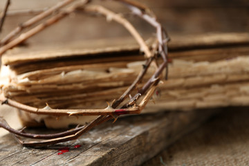 Crown of thorns with blood and bible, close up