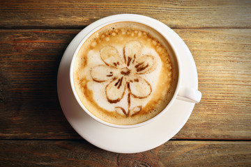 Cup of coffee latte art on wooden background