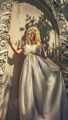 Fototapeta na wymiar Pretty woman in white dress in the Greek style