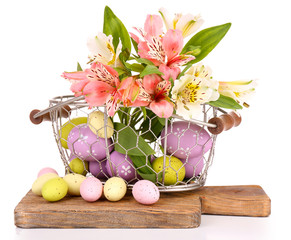 Easter composition with Easter eggs in basket and flowers,
