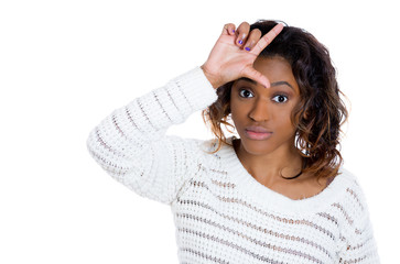 Closeup portrait of young woman showing loser sign