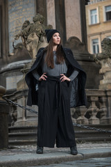 Fashion photo of model woman in black clothes in the city