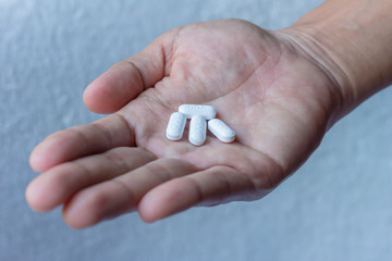 pills in man hand