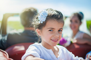 wedding day, portrait of a girl at the back of a retro car