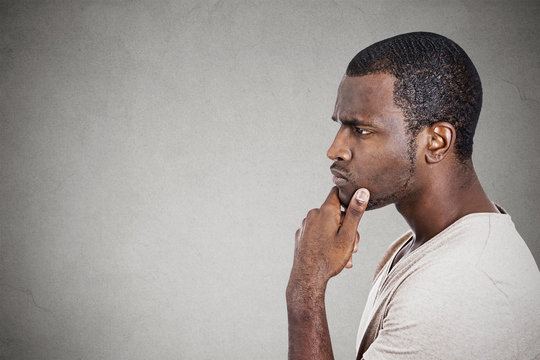 Portrait thoughtful young man isolated ion gray background 