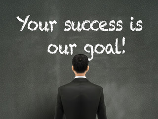 businessman looking at your success is our goal words