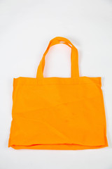 Orange cotton bag isolated white background.