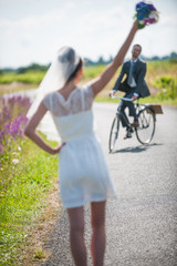 The groom is coming back for his bride on a bike