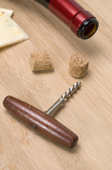 Fototapeta na wymiar Empty Wine Bottle with Antique Corkscrew and Cheese