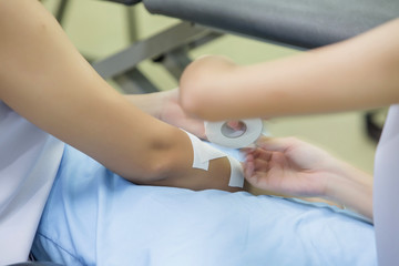 applying tape to a patient's arm