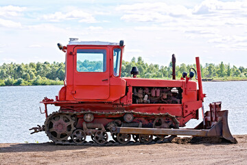 Bulldozer red by the river