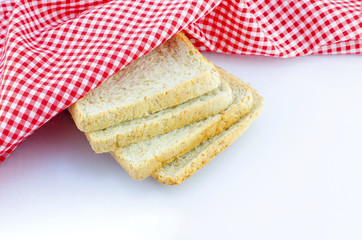 sliced wholewheat bread and napkin on white background with plac