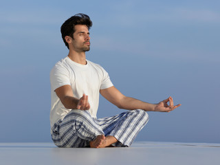 Fototapeta na wymiar young man practicing yoga