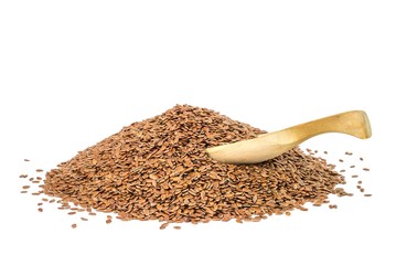 Pile of linseed with a wood spoon on white background