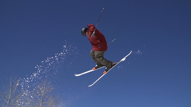 Slow Motion Man Skiing Doing Spin Off Jump