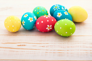 Obraz na płótnie Canvas Easter eggs on white wooden desk. Festive background toning 