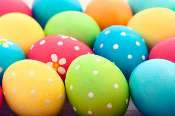 Fototapeta na wymiar Easter eggs on white wooden desk. Festive background toning 