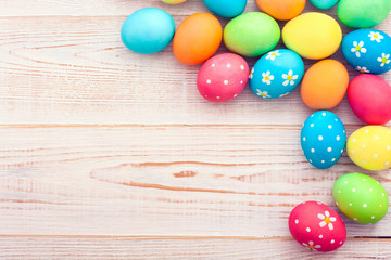 Easter eggs on white wooden desk. Festive background toning 