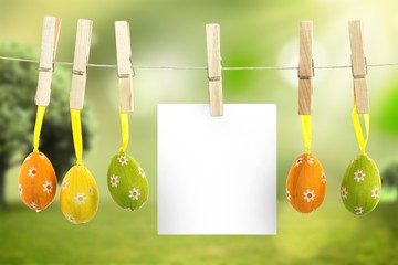 Composite image of hanging easter eggs