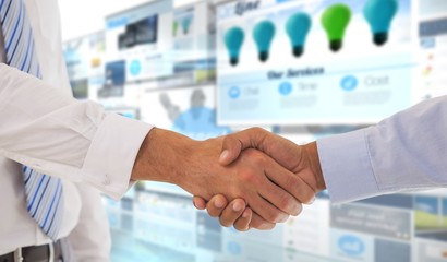 Composite image of close-up shot of a handshake in office