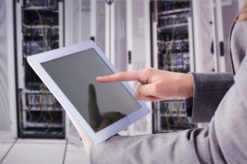 Composite image of businesswoman using a tablet pc