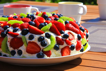 Cake "Pavlova" richly garnished with fresh berries