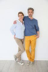 Cheerful mature couple on white background