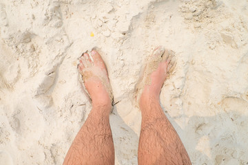 man legs on sandy beach