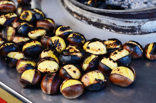 Grilled chestnuts for sale in a market stall