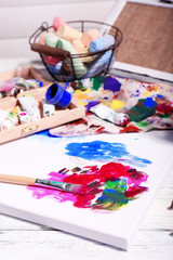 Professional art materials on color wooden background