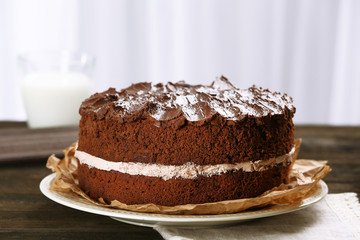 Delicious chocolate cake on table on light background