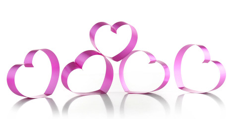 Purple hearts from ribbon isolated on white