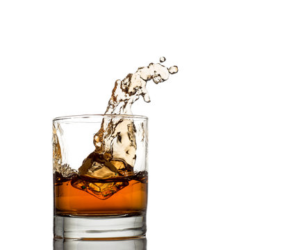 Isolated shot of whiskey with splash on white