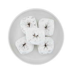 Powdered sugar donuts on a plate