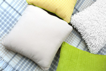 Decorative pillows on plaid close up