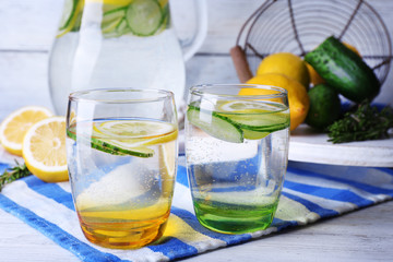 Fresh water with lemon and cucumber in glassware
