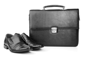 Black leather briefcase with shoes isolated on white