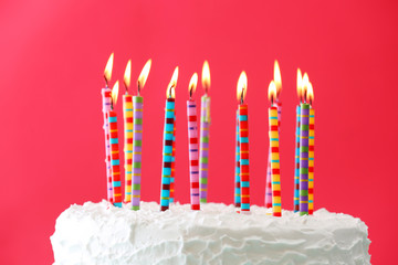 Birthday cake with candles on color background