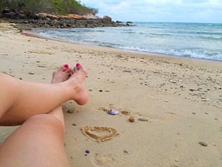 girl sitting alone on beach.