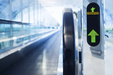 Escalator walkway with Arrow sign at the Airport