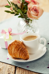 Romantic breakfast with coffee and croissant