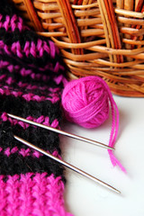Knit scarf with stripes and a ball of yarn.