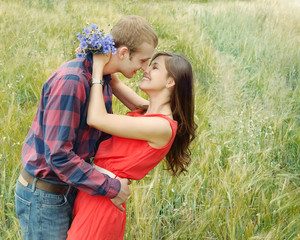 sensual outdoor portrait of young smiling attractive couple in l
