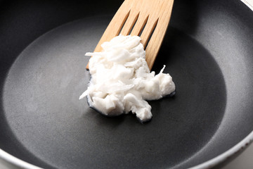 Coconut oil in frying pan close up