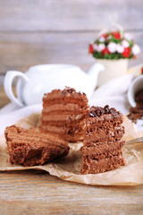 Slices of tasty chocolate cake on plate on table close up