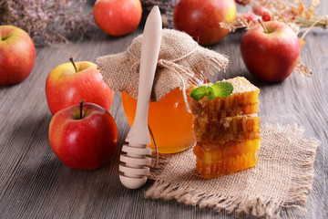 Delicious honey with apple on table close-up