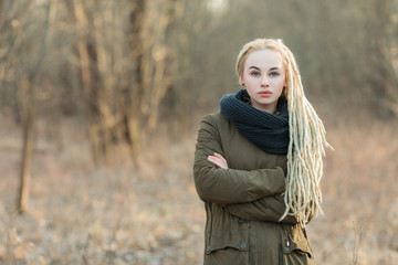 Young blonde hipster woman dreadlocks hairstyle cold season