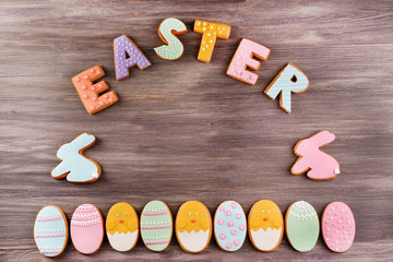 Delicious Easter cookies on wooden background